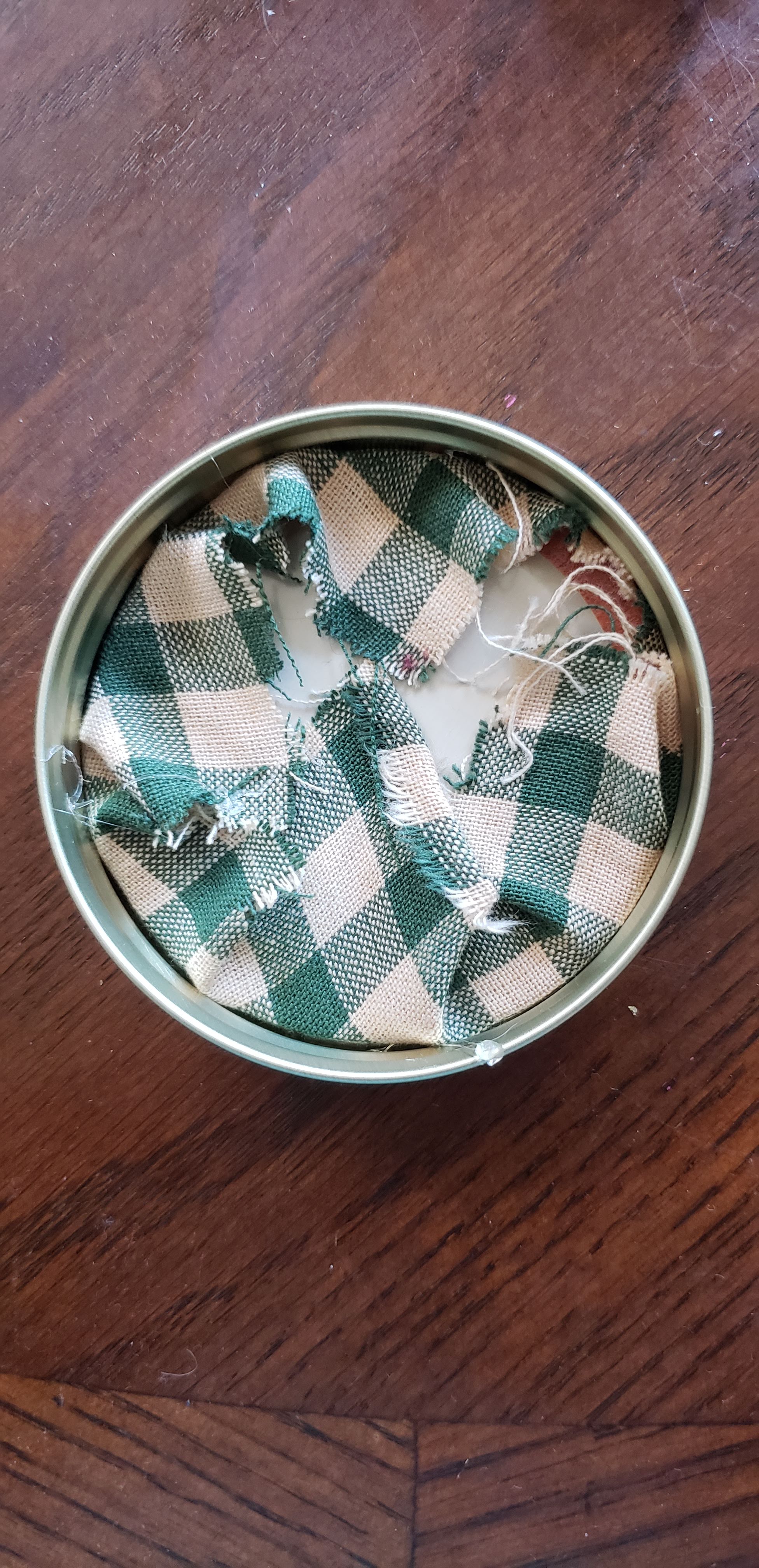 step2 - fold the fabric over the mason jar lid and glue