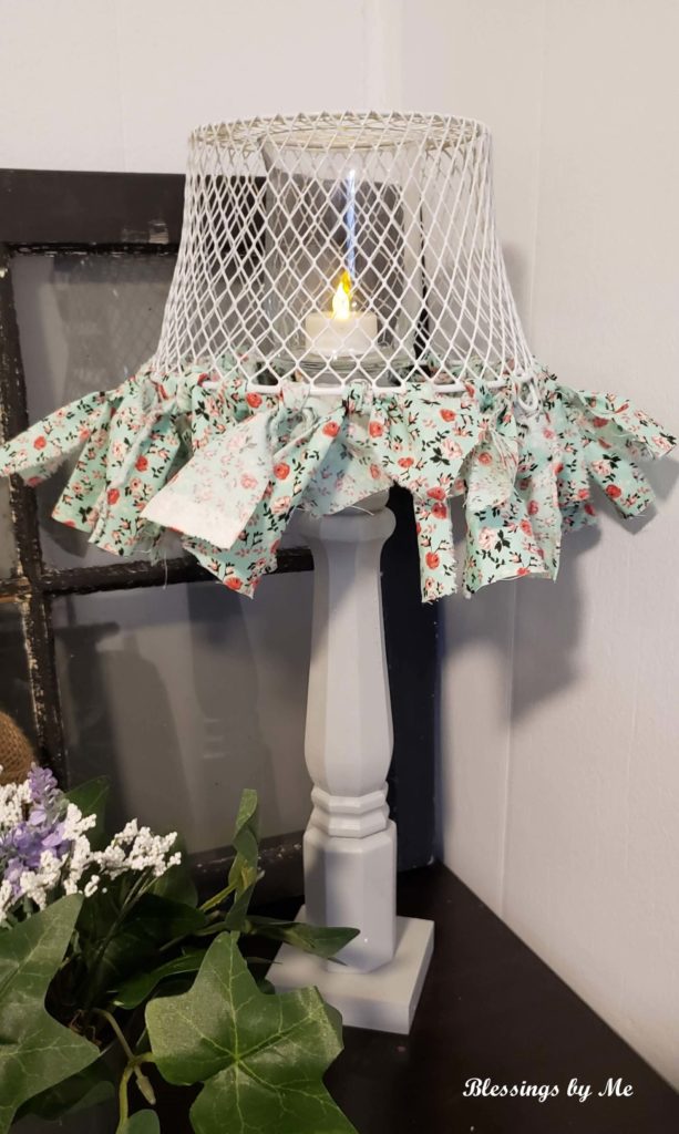 Put the tea light candle in the candle holder and turn the basket upside down over the candle holder