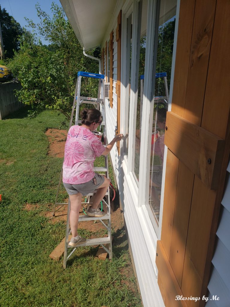 Painting the windows to bring out the shutters