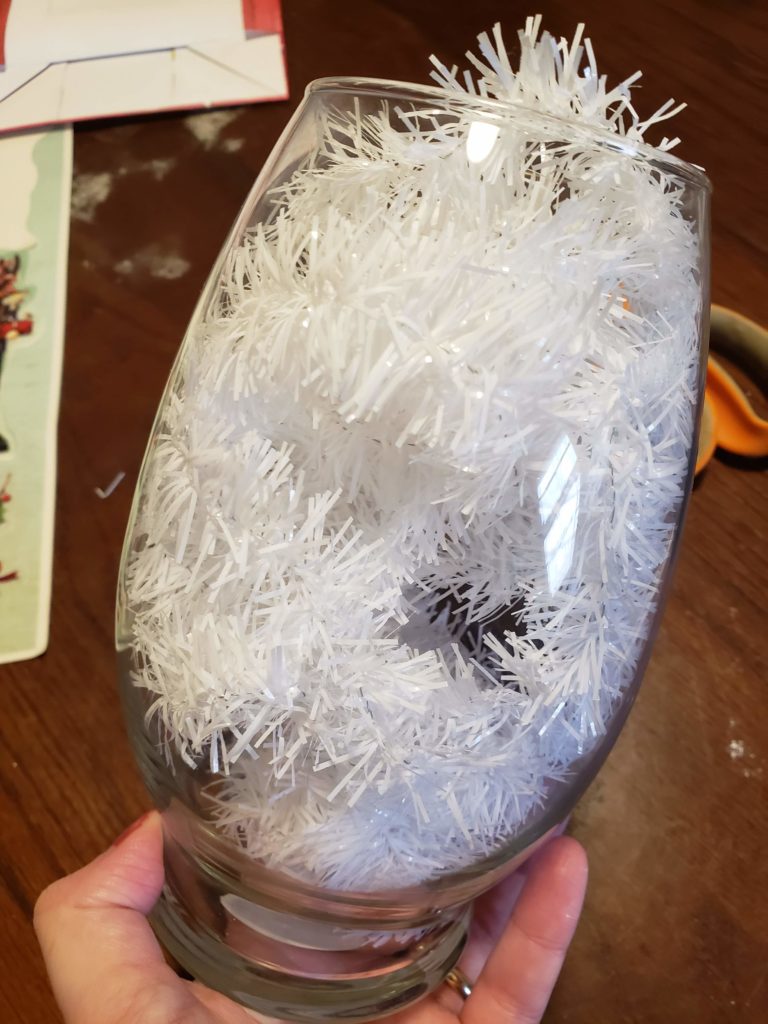 Add tinsel to the vase