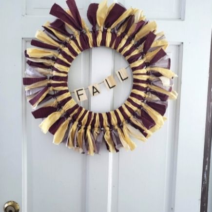 fall wreath with popsicle stick banner